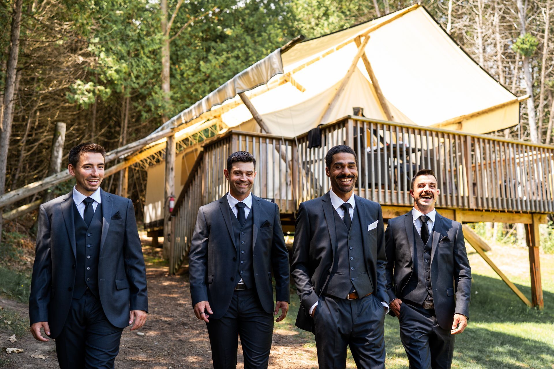 Wedding party in front of luxury glamping tent at Whispering Springs