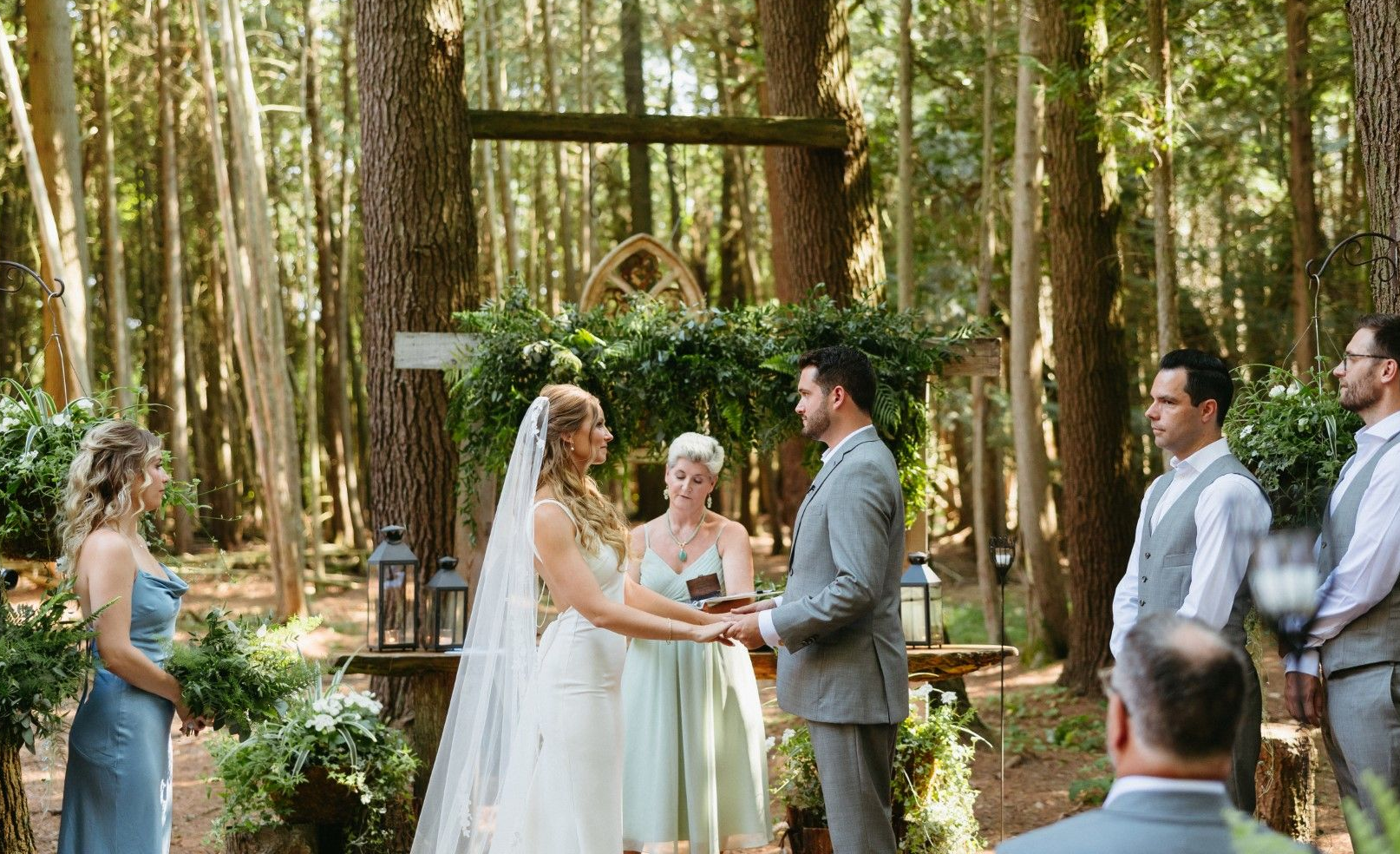 A couple says vows in the beautiful forest chapel at Whispring Springs Wilderness Retreat
