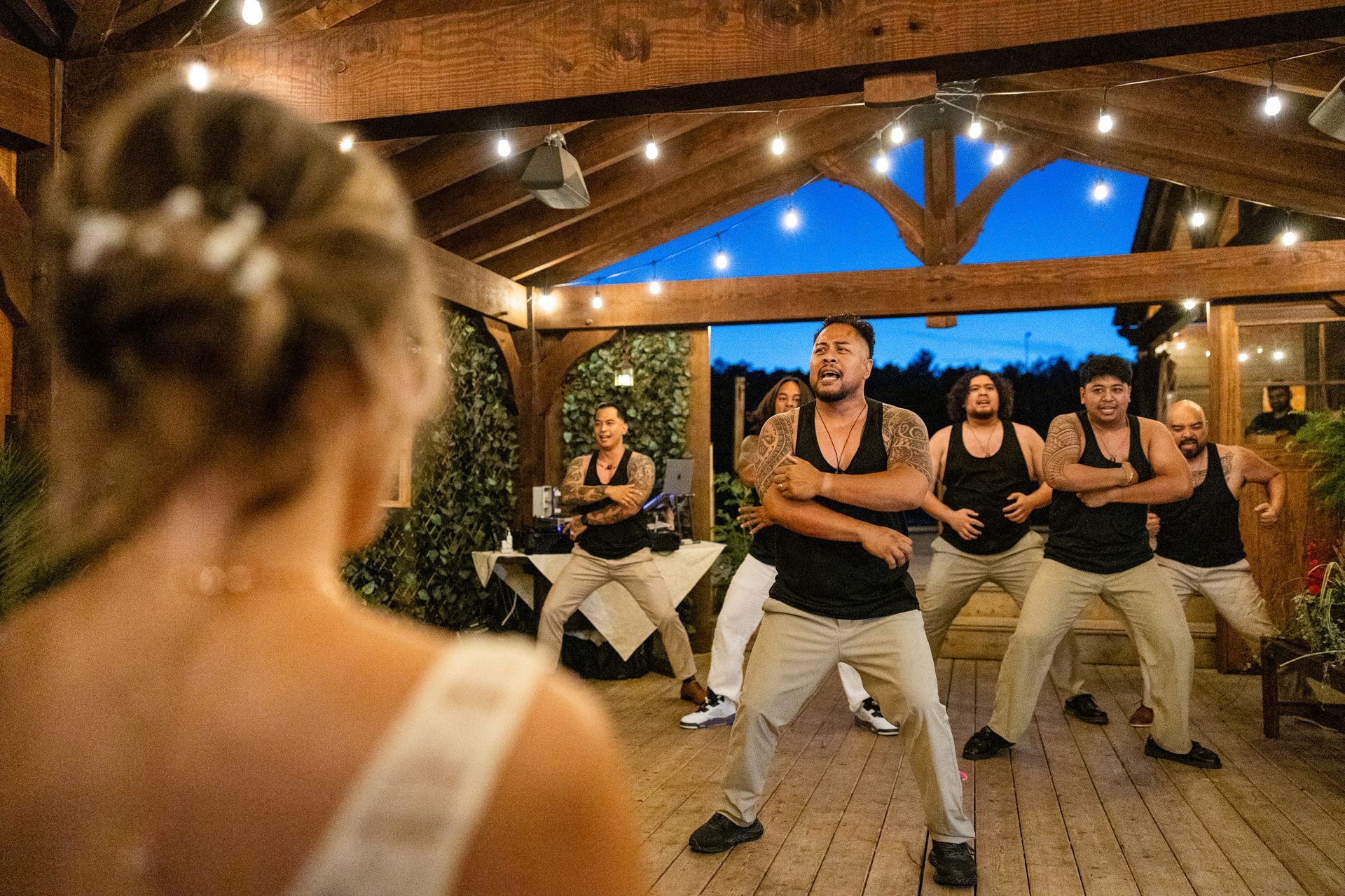 Groom and wedding party performs traditional dance for bride