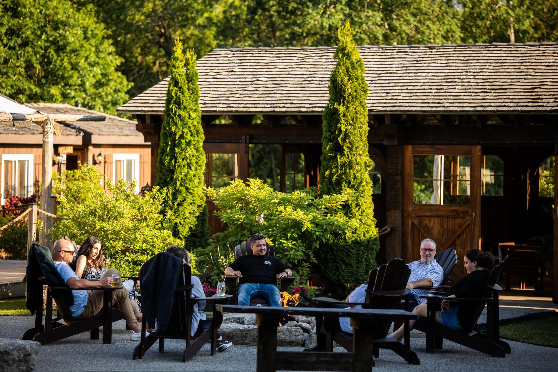 Colleagues sitting around the Whispering Springs firepit at a corporate retreat.