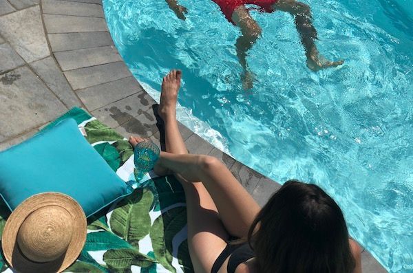 Sitting at the pool at Whispering Springs luxury glamping in Ontario