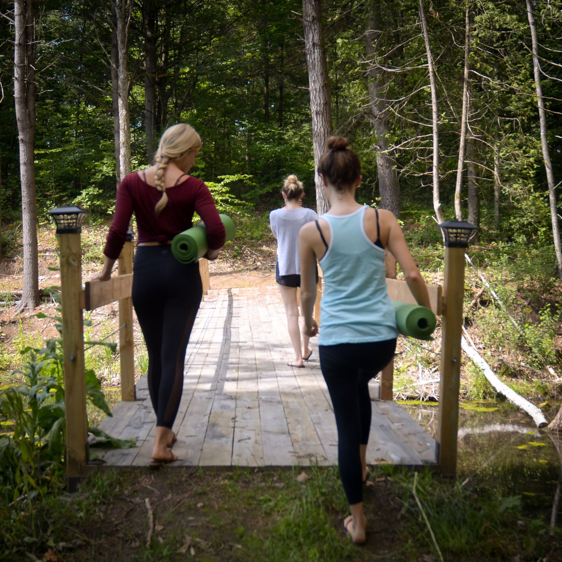 Women walking with yoga mats at Whispering Springs
