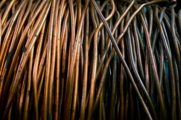 Close-up of tangled copper wires used for ferrous metal recycling at industrial scrap facility.