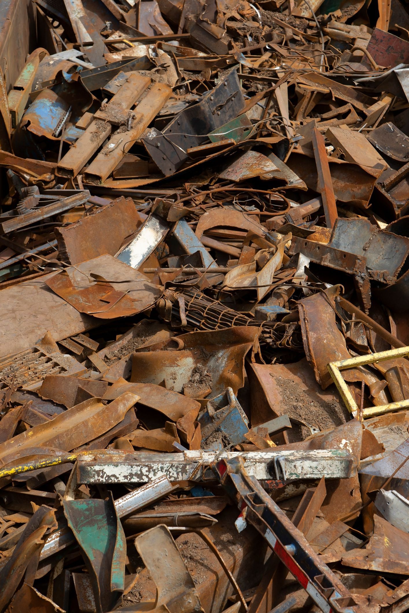 A load of scrap metal in a gondola car travels by freight train for recycling purposes.