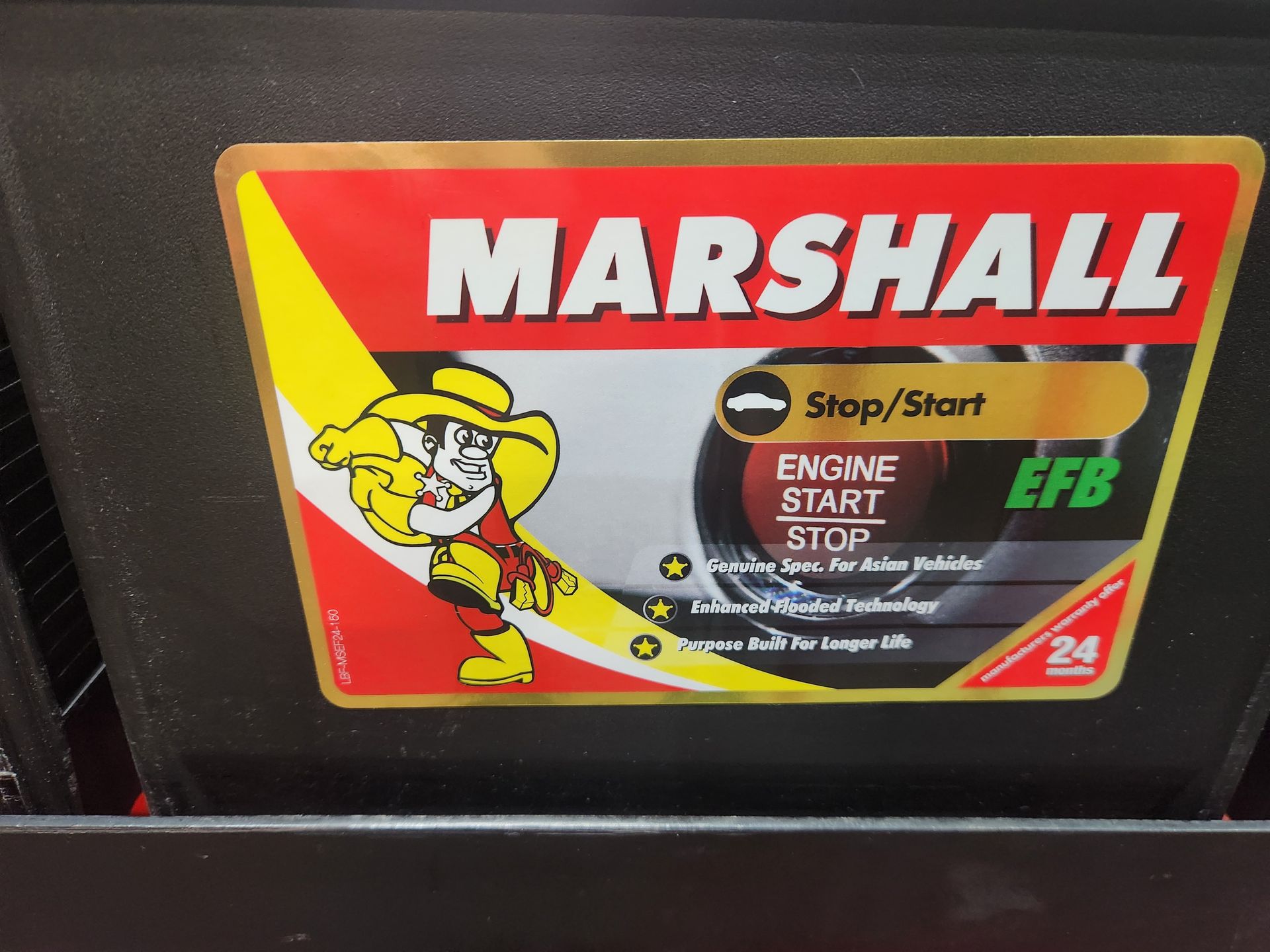 A Person Is Fixing A Car Battery With A Wrench — Marshall Batteries & Cairns Mobile Batteries In Manunda, QLD