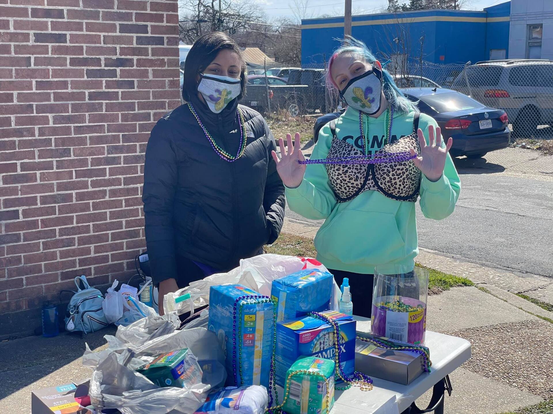 Heart for the City campaign member standing in front of a table of donations