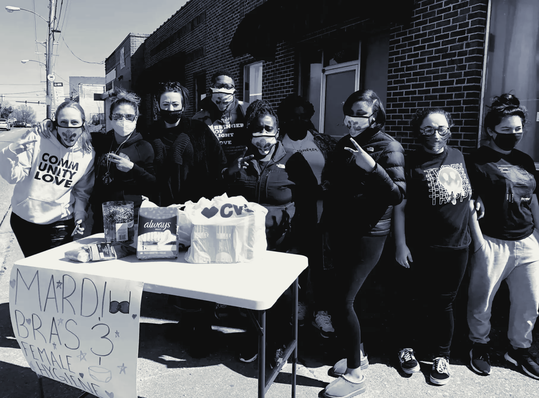 members from the outreach ministry standing in front of a table of donated goods