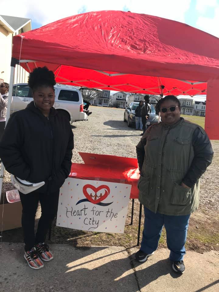 2 people standing under a tent
