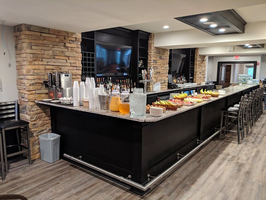 There is a long bar in the middle of the room.