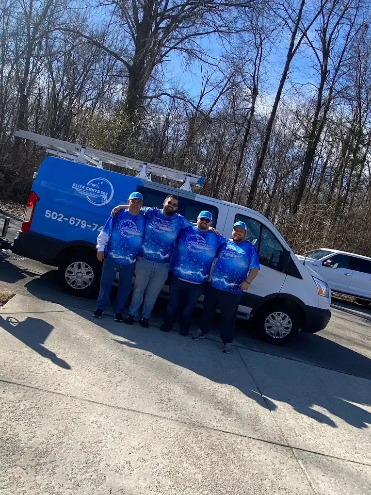 A group of men are posing for a picture in front of a van.