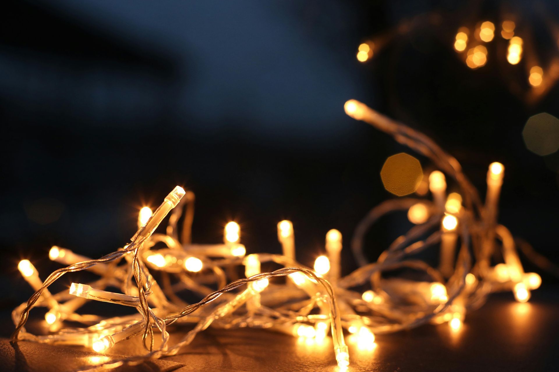 String lights, soft yellow glow, against a dark background.