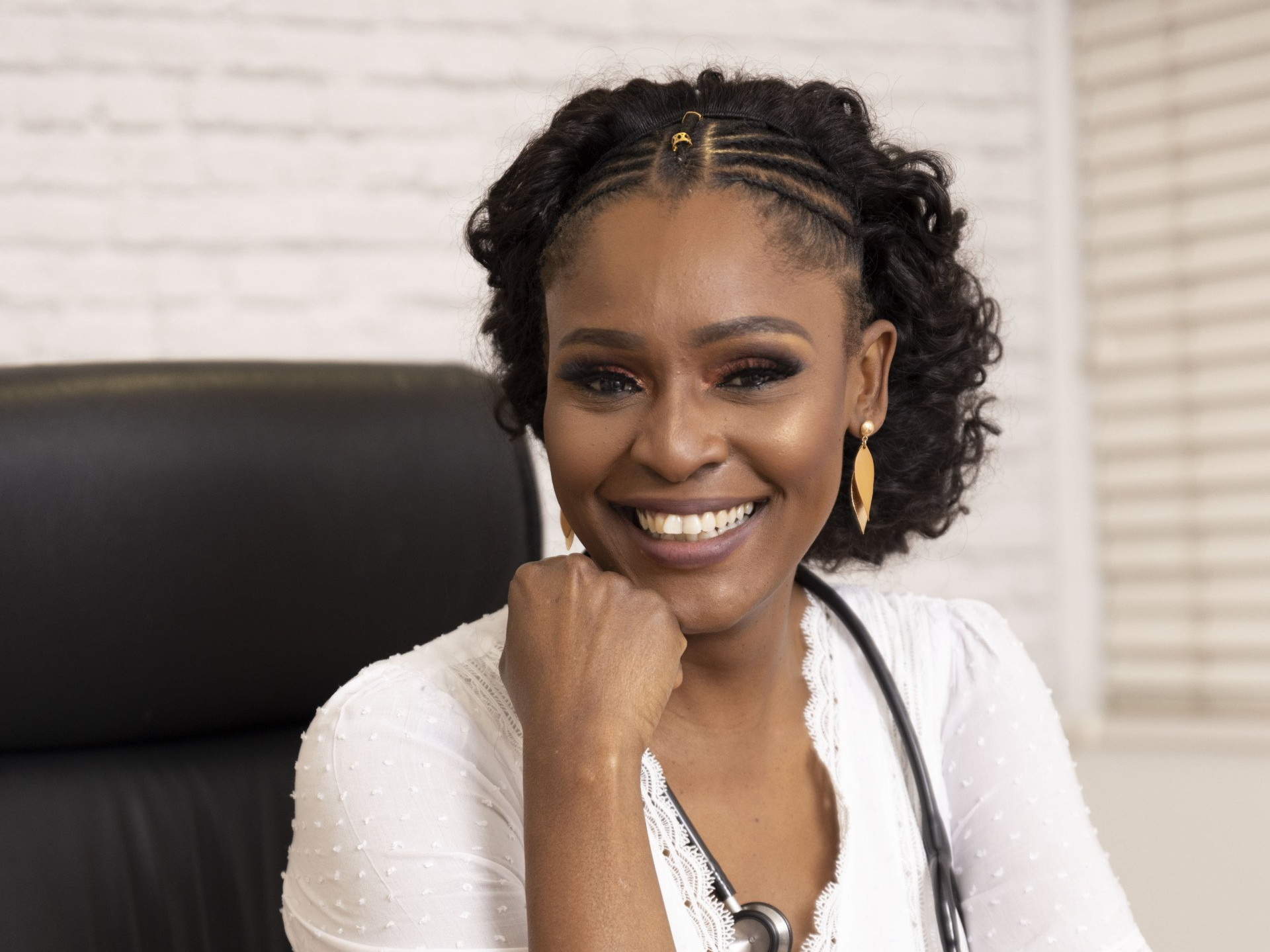 dr lethabo machaba sitting in chair smiling posing for a photo