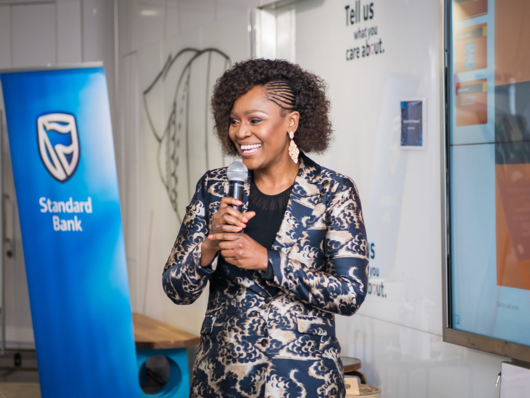 professional woman holding a micrphone and delivering a speech