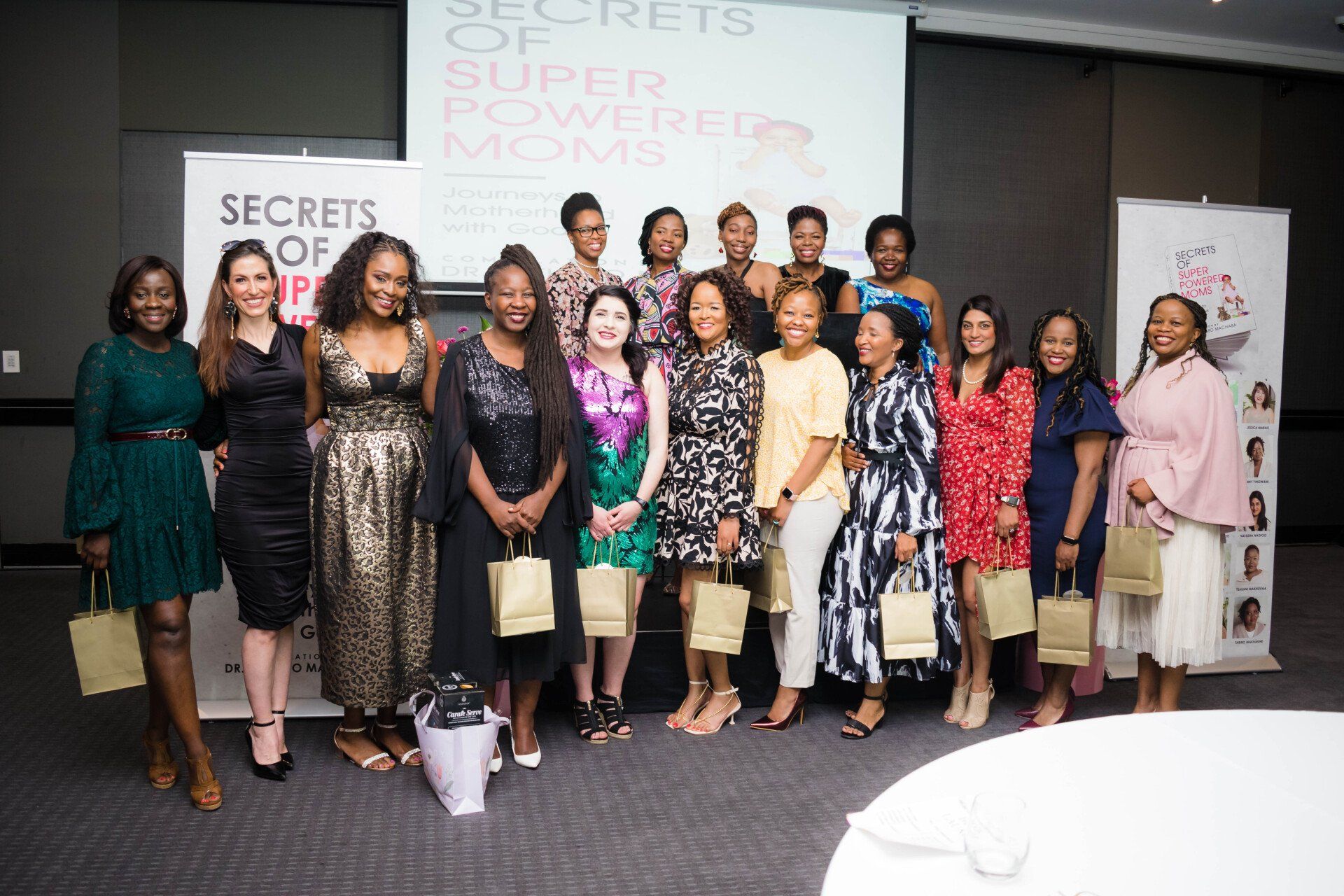 group of professional woman posing for a photo at an evening event