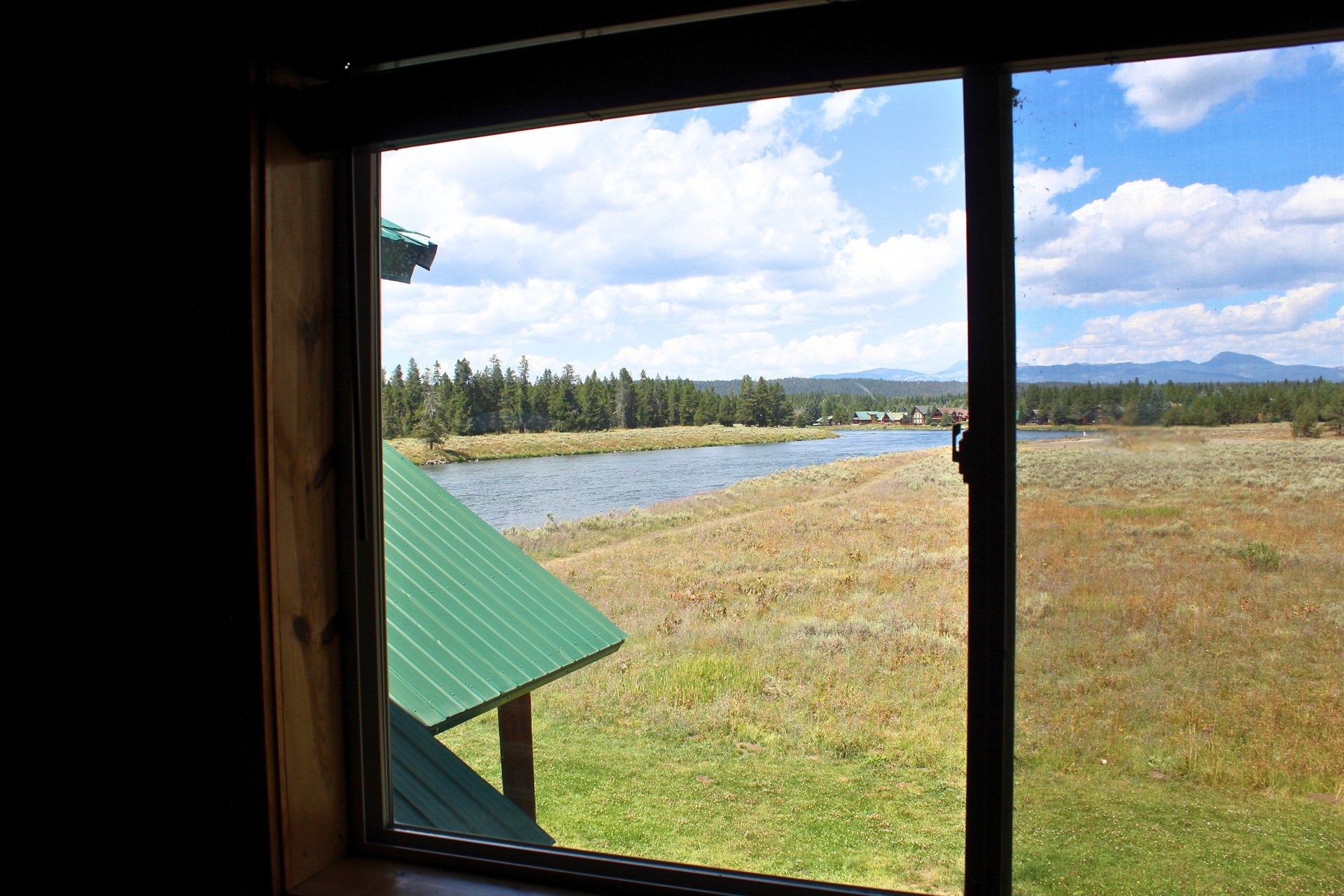 A window with a view of a lake and mountains