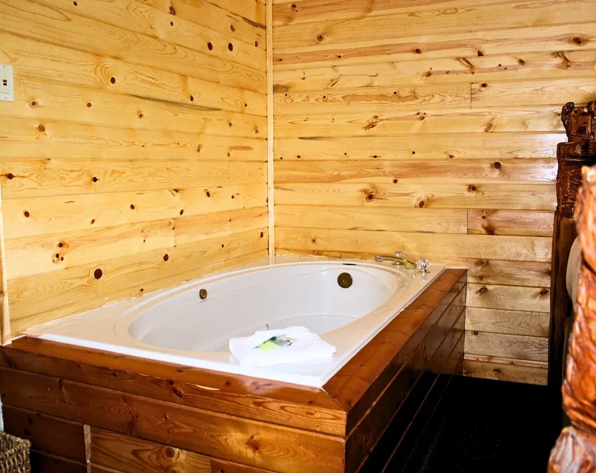 Jacuzzi tub in a wood-paneled room.