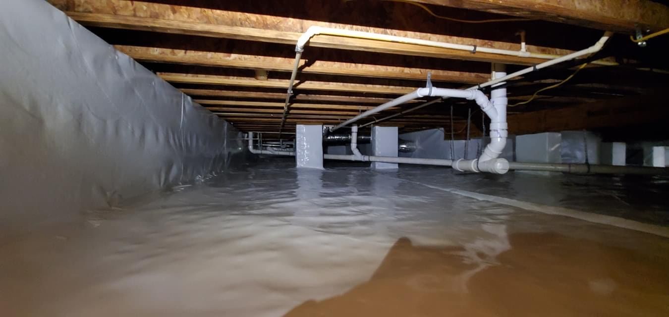 Floodwater beneath a low wooden structure, with muddy water filling the space
