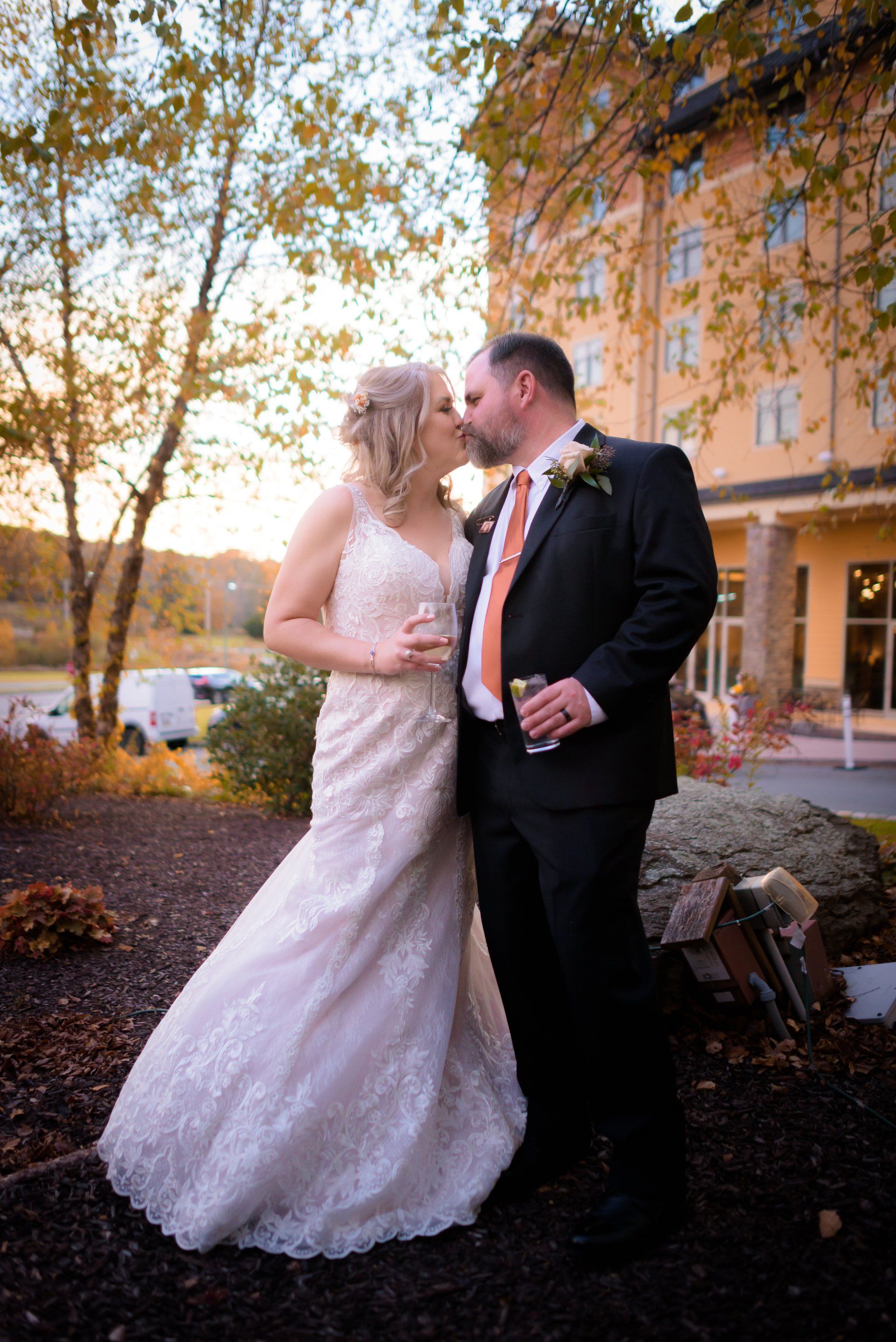 Wedding Couple walking ouside of a venue kissing in the Poconos, Pennsylvania