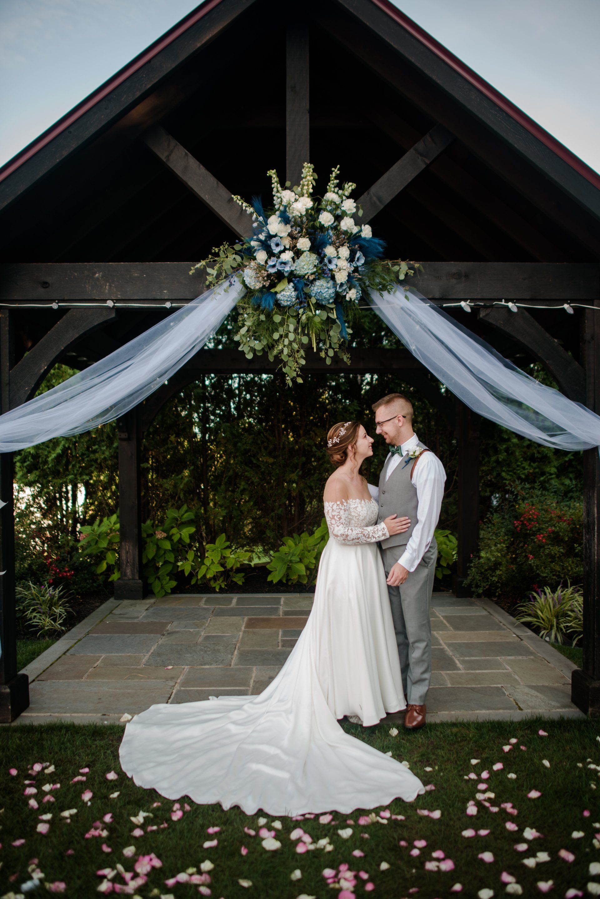 Wedding Couple walking ouside of a venue kissing in the Poconos, Pennsylvania