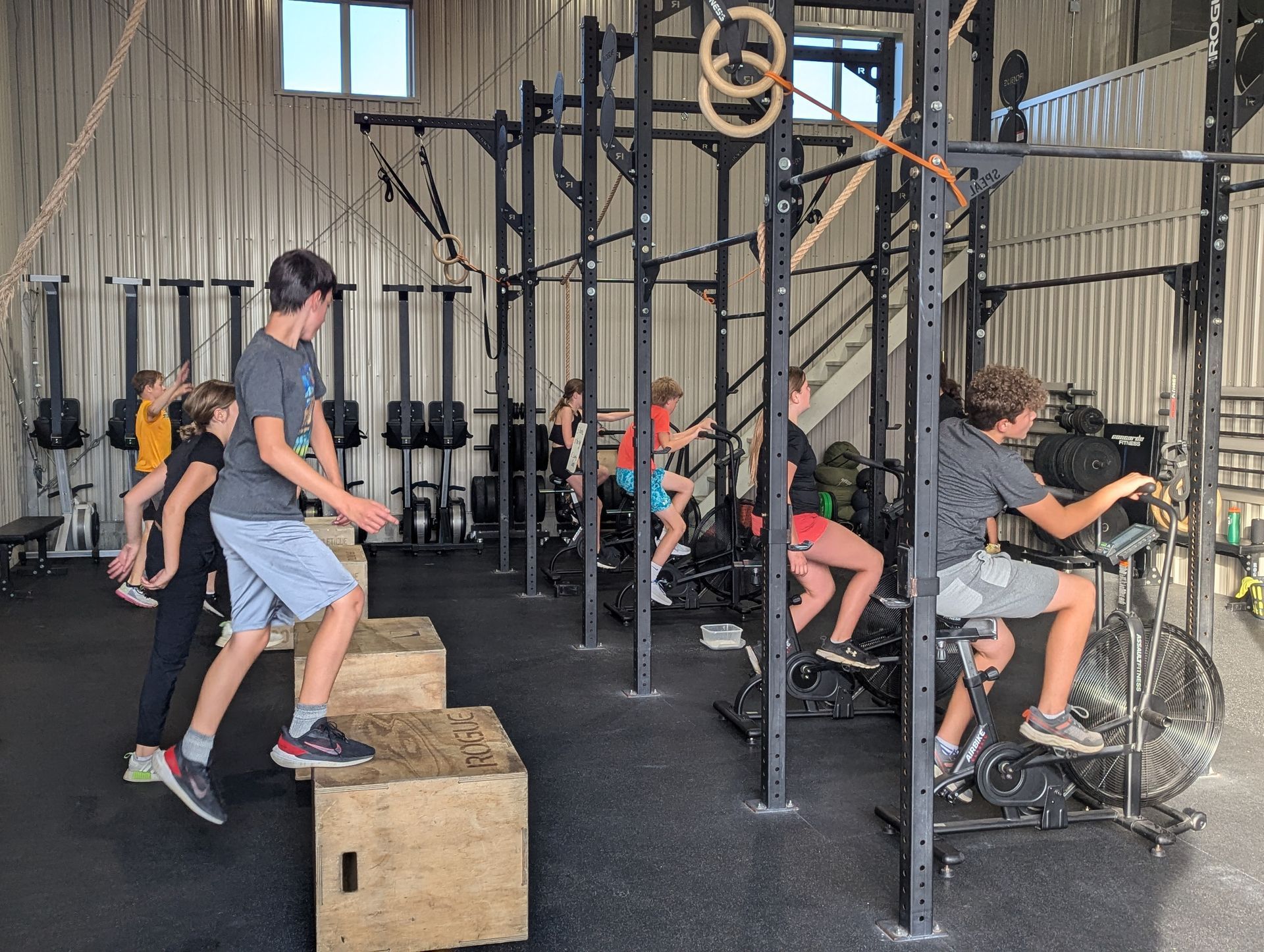 A group of people are doing exercises in a gym.