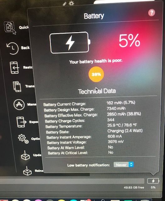 A computer screen shows a battery percentage of 5%