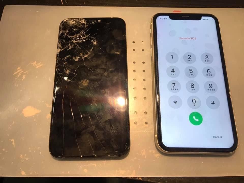 A phone with a broken screen is next to a phone with a broken screen.