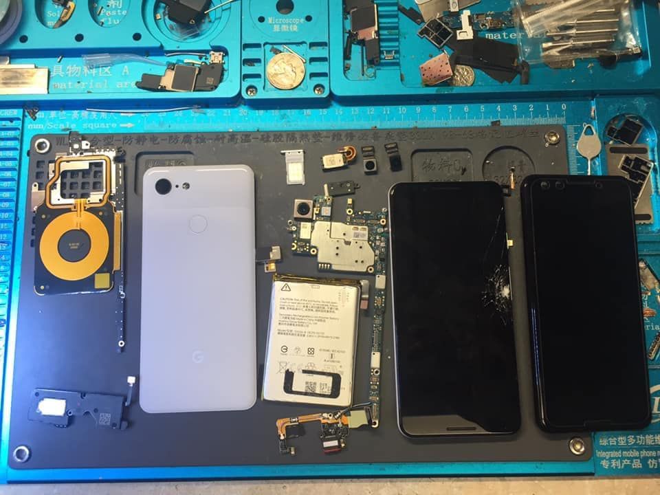 Two cell phones are sitting on top of a board.