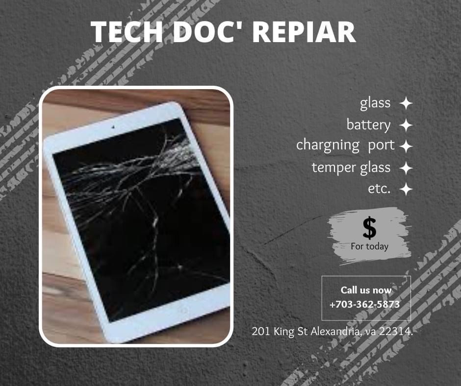 A tablet with a broken screen is sitting on a table.