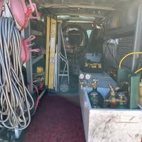 The inside of a van filled with lots of tools and equipment.