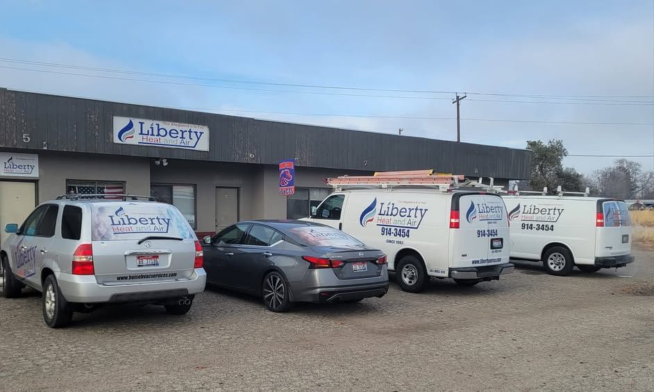A row of liberty vans are parked in front of a building.