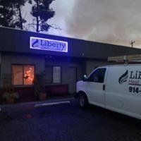 A white van is parked in front of a building.