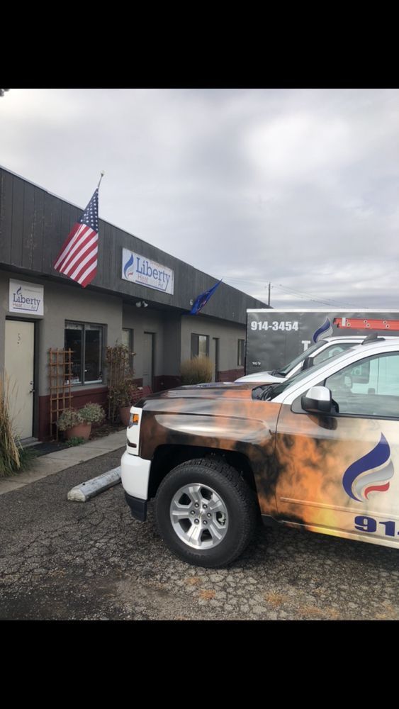 A white truck is parked in front of a building.