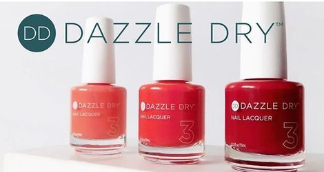 Three bottles of Dazzle Dry nail polish in shades of orange and red.