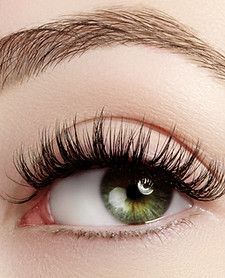 A woman is getting her hair washed in a sink at a salon.
