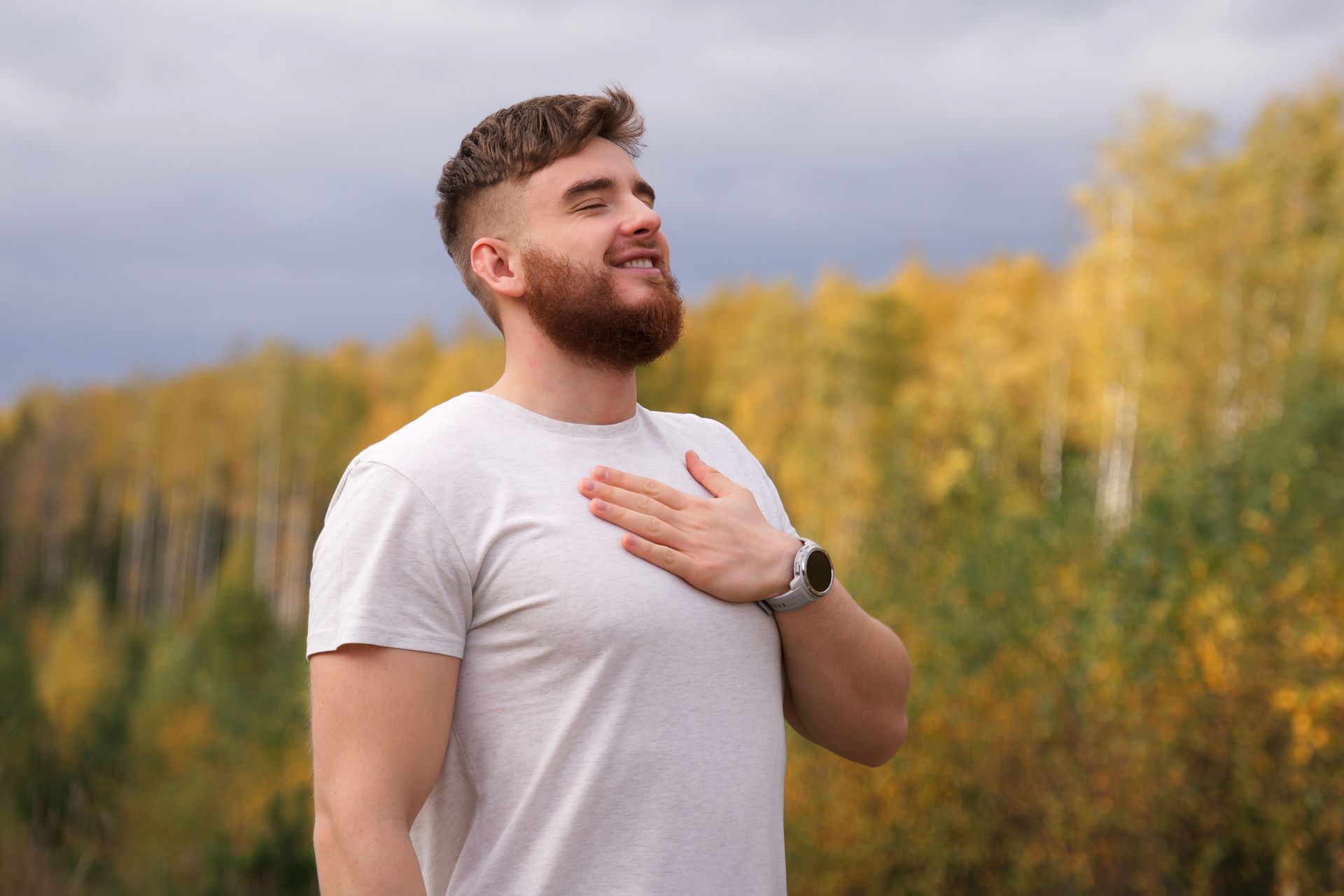 Man with hand on chest.