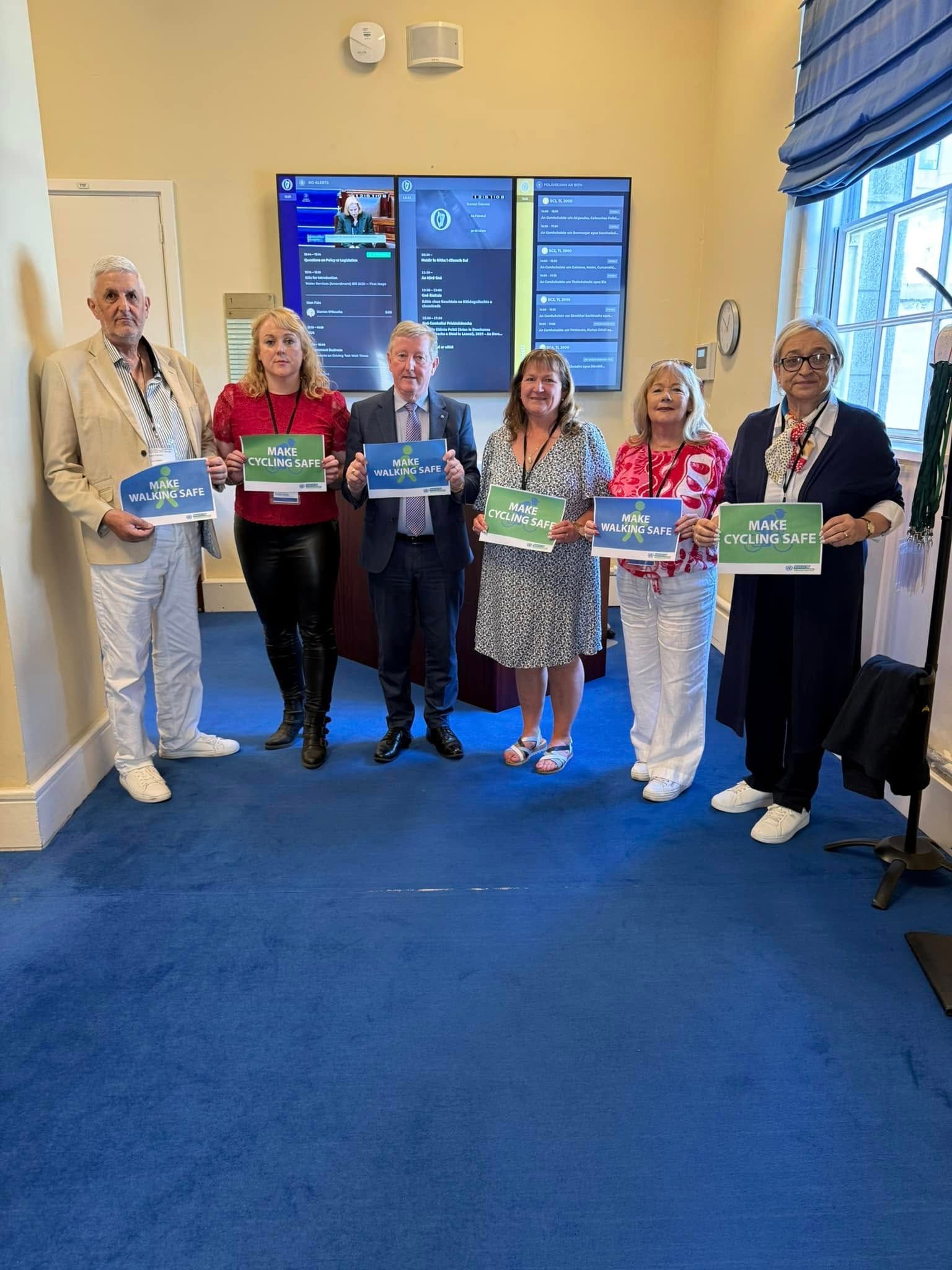 A group of people are standing in a room holding signs.