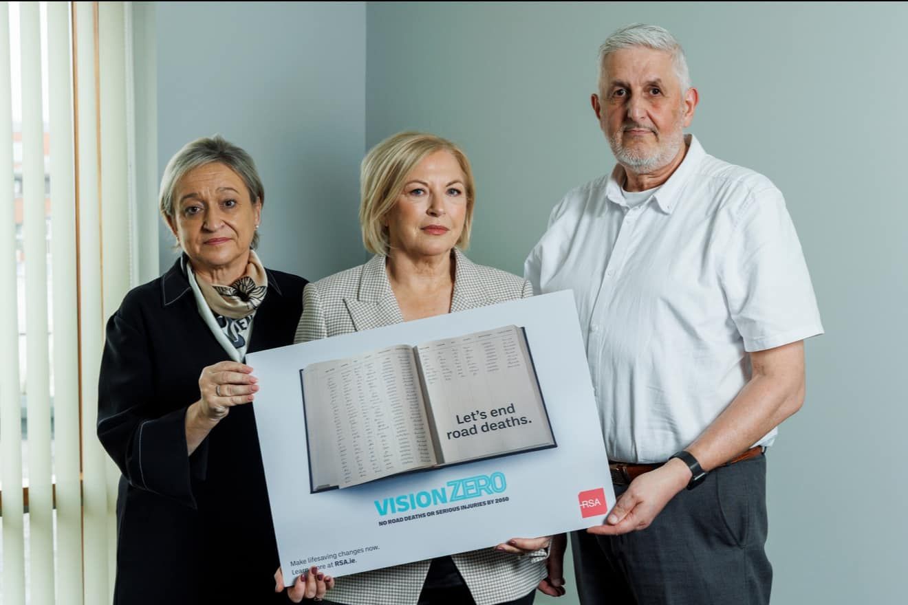Three people are holding a sign that says vision zero