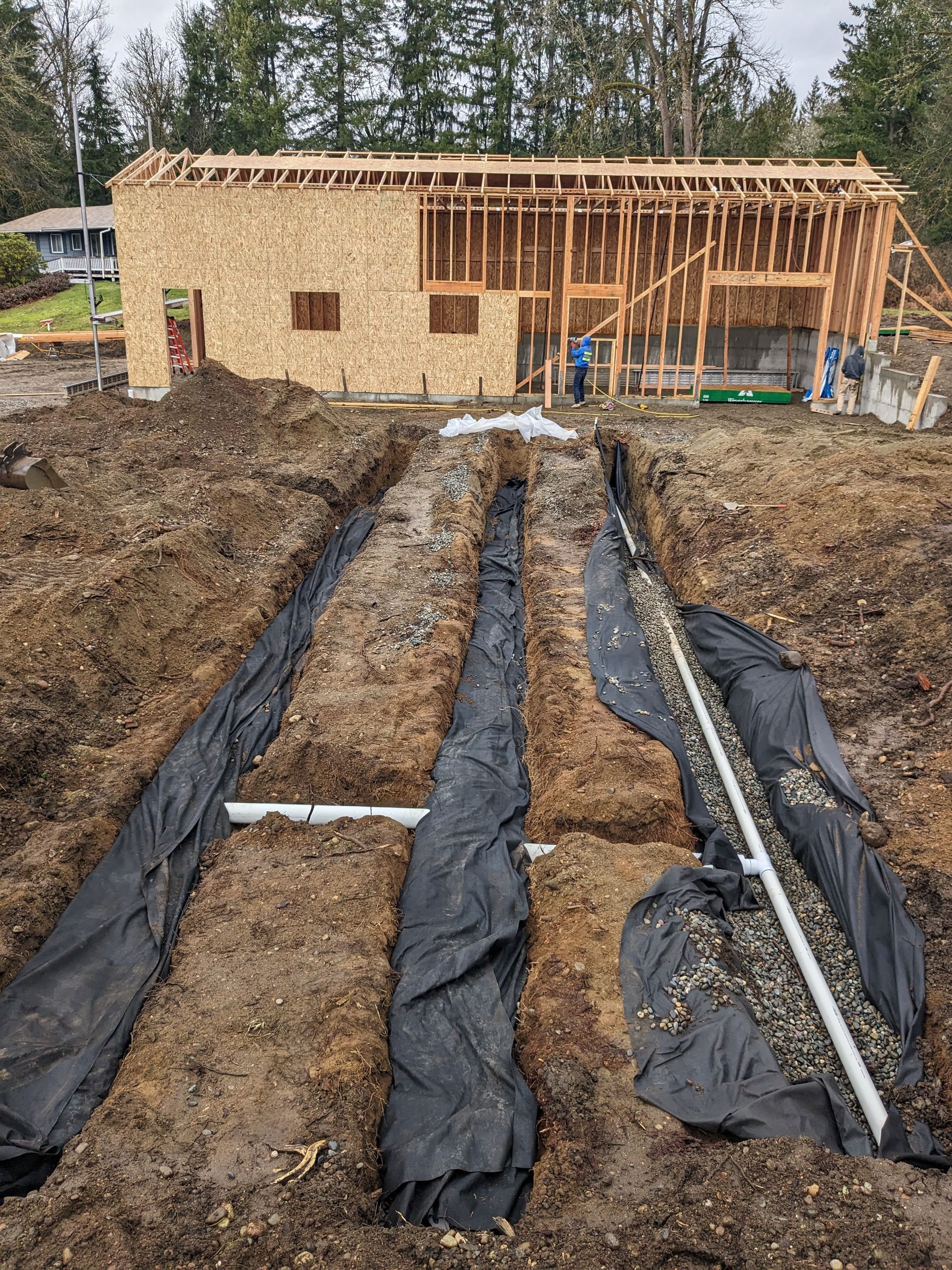 A house is being built in the middle of a dirt field.