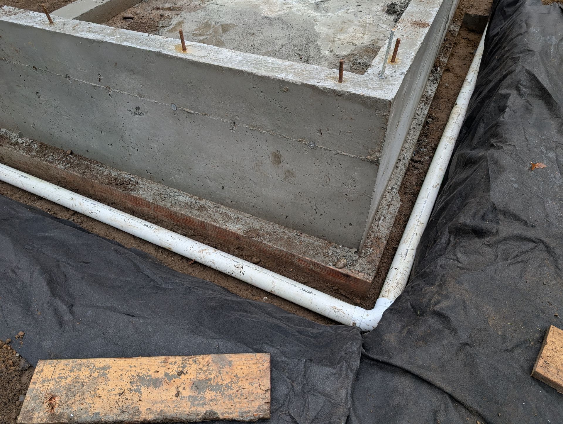 A concrete block is sitting on top of a black tarp.