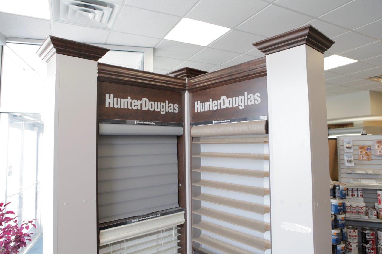 Two HunterDouglas blind displays in a store, showing different blind styles.