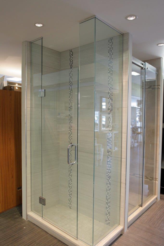 A shower stall with a sliding glass door in a bathroom.
