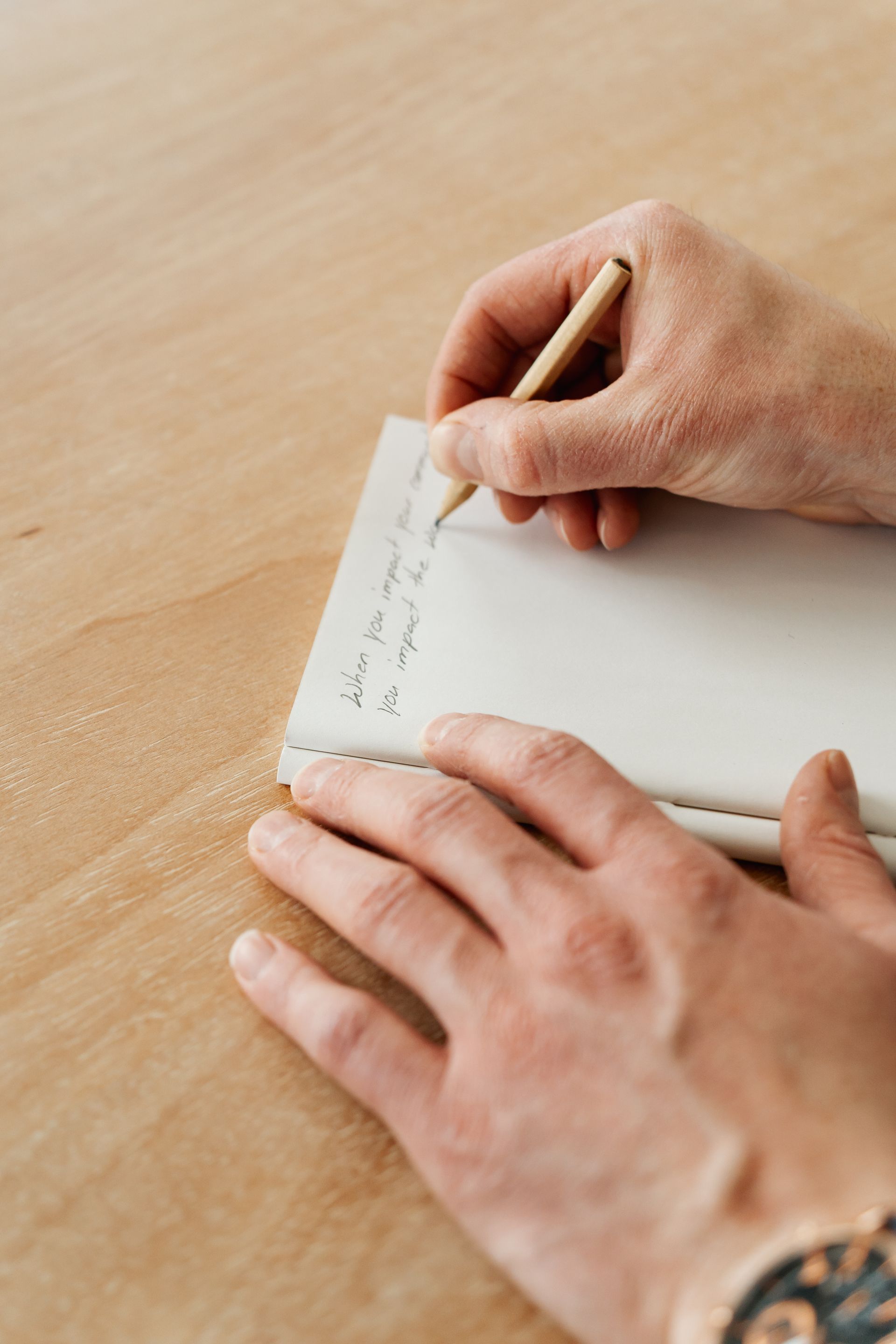 Specialty coffee roastery in Mount Vernon Ohio's local founder writes mission statement in notebook, to impact community