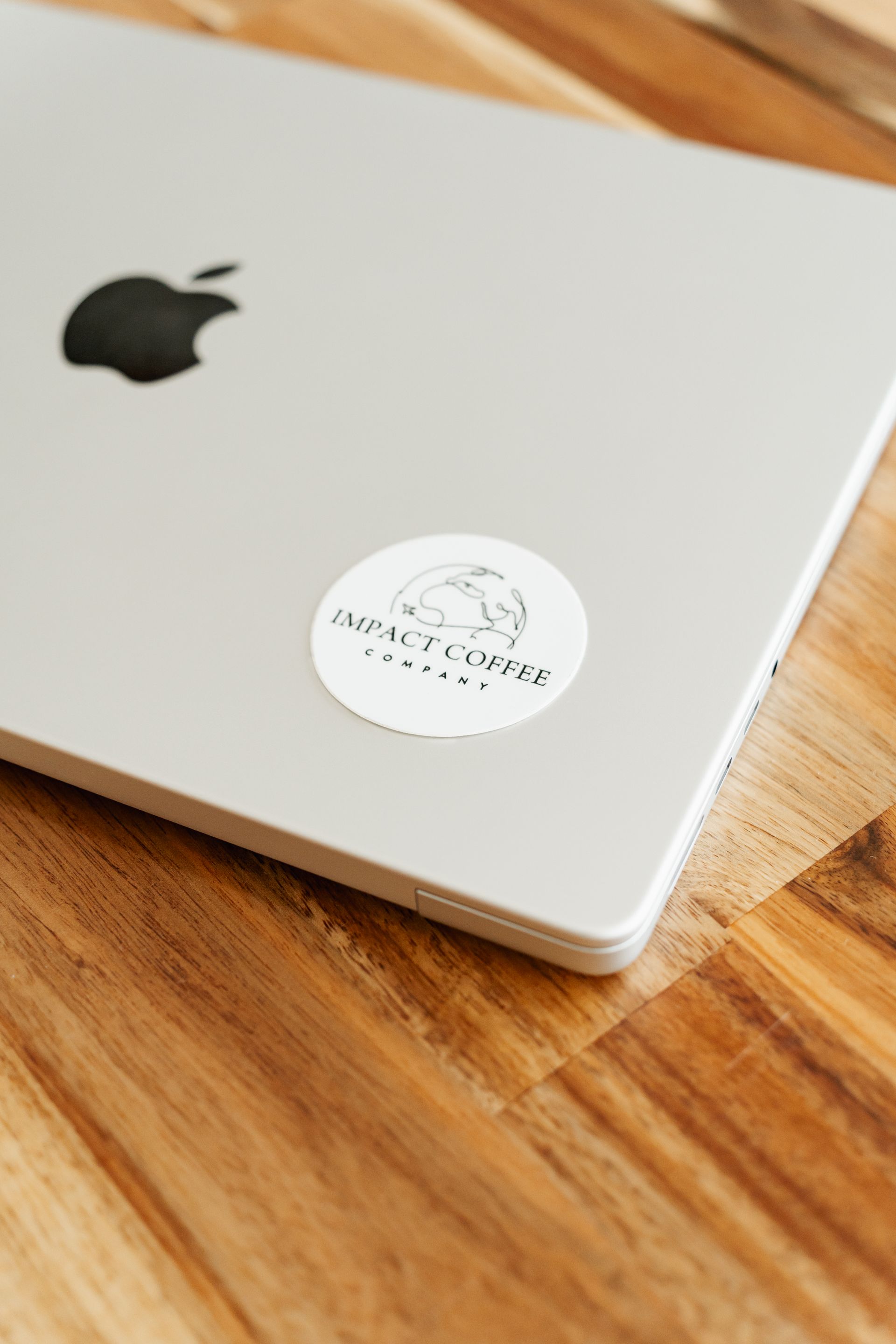 A logo for a coffee company called impact coffee company.