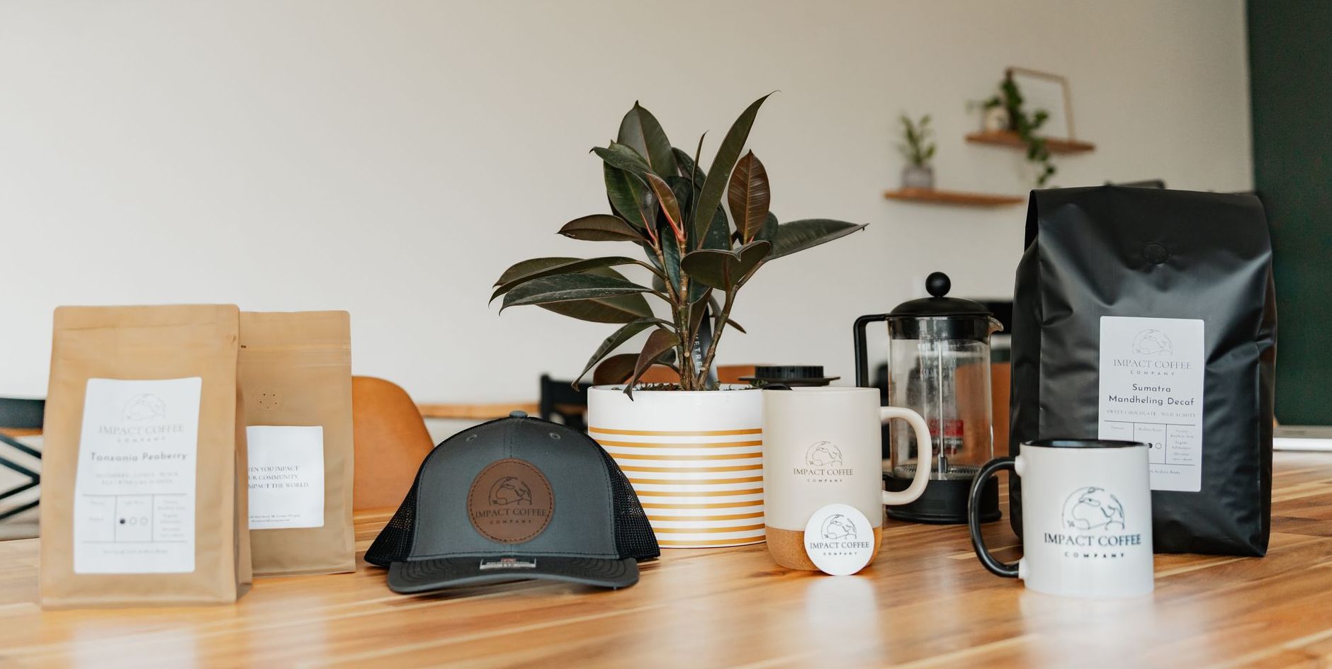 A man wearing glasses and a hat is standing in front of a brick wall.