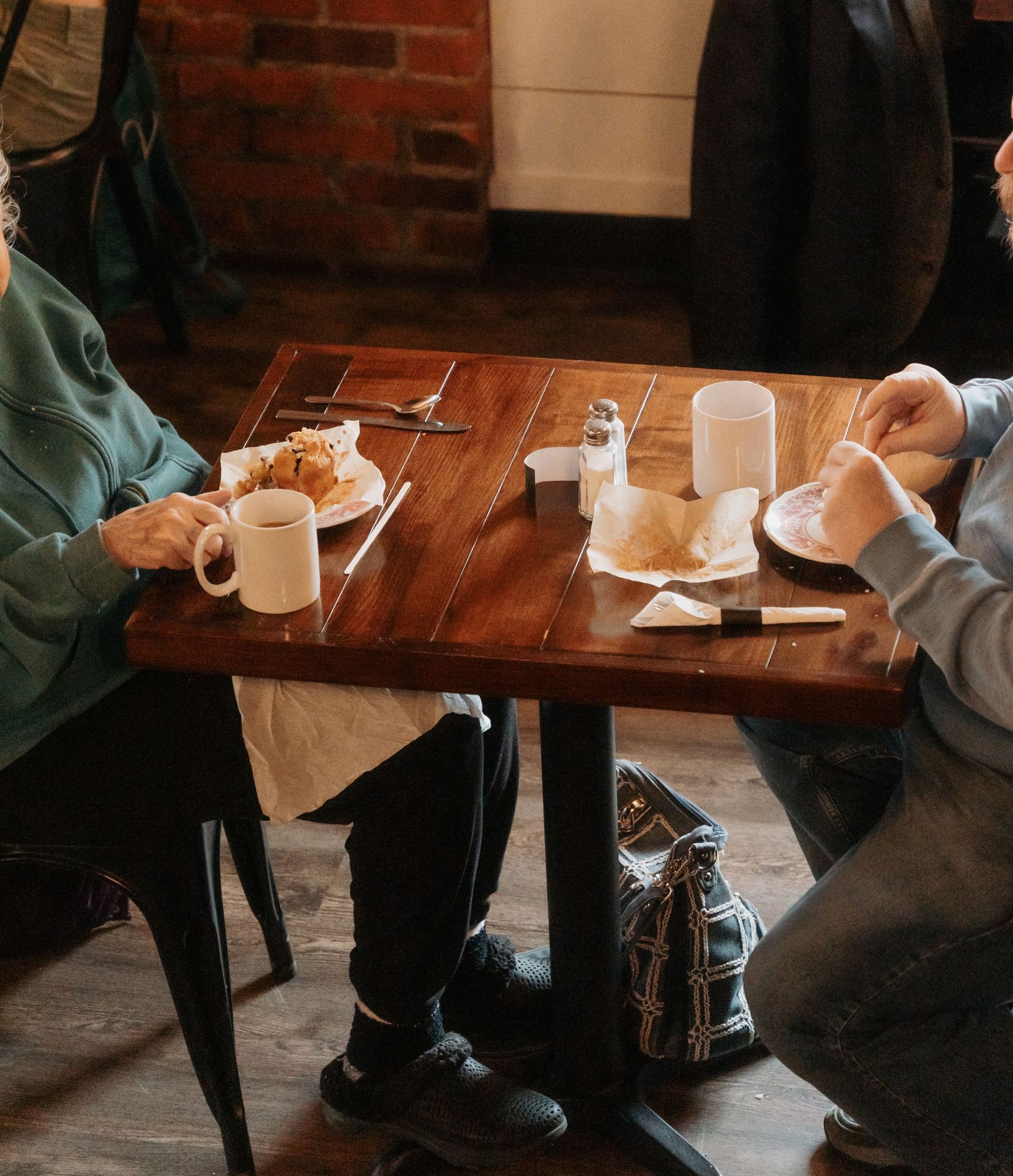 Man and woman share specialty coffee and  homeade pastries at local coffee shop and cafe in Mount Vernon Ohio