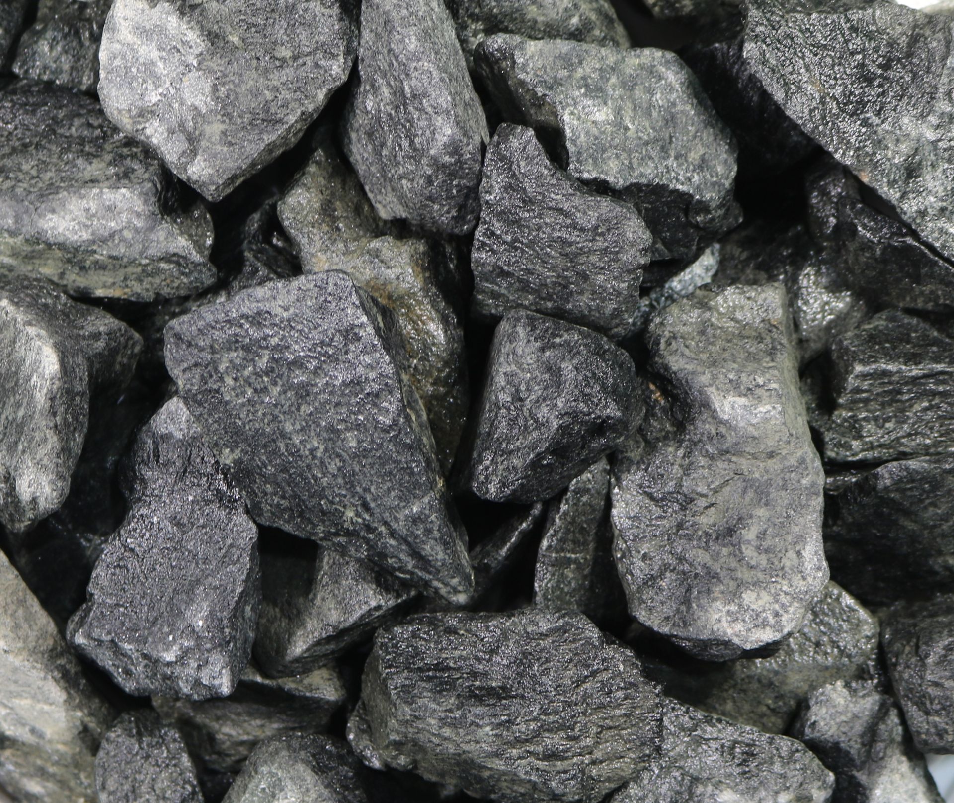 A pile of rocks on a white plate on a white background.