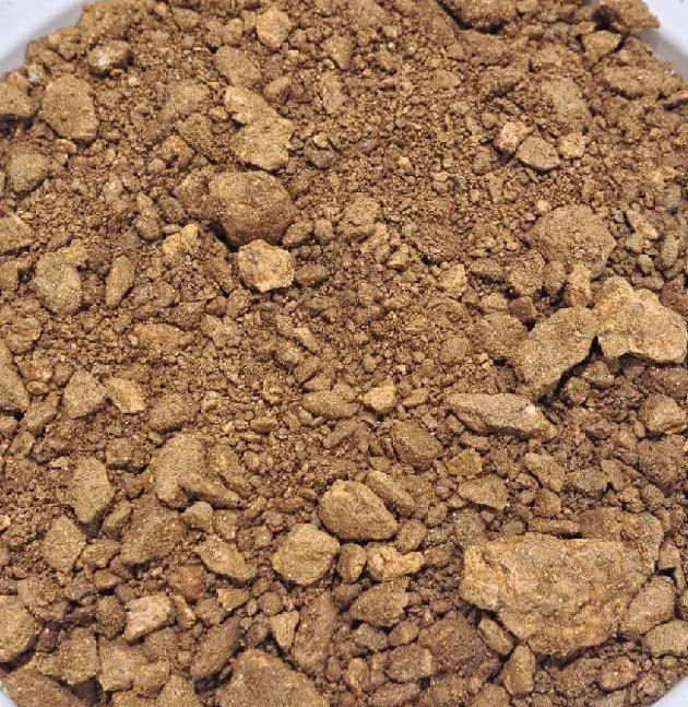 A white plate topped with a pile of brown rocks.