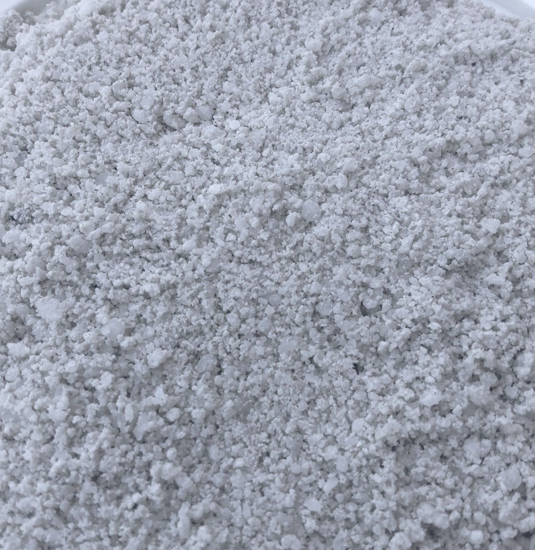 A white plate topped with a pile of white rice.