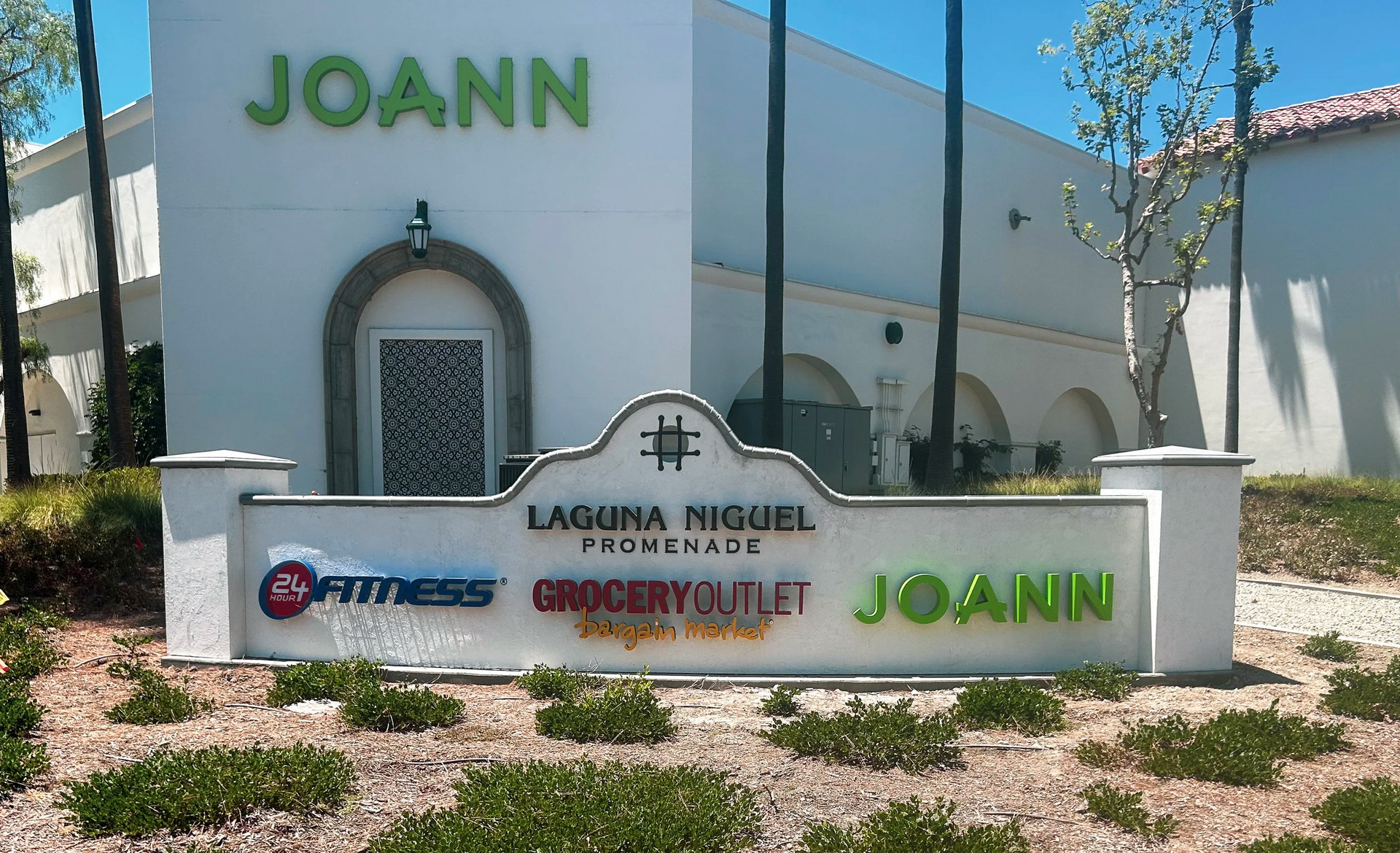 JOANN store sign at Laguna Niguel Promenade with other businesses: 24 Hour Fitness and Grocery Outlet.