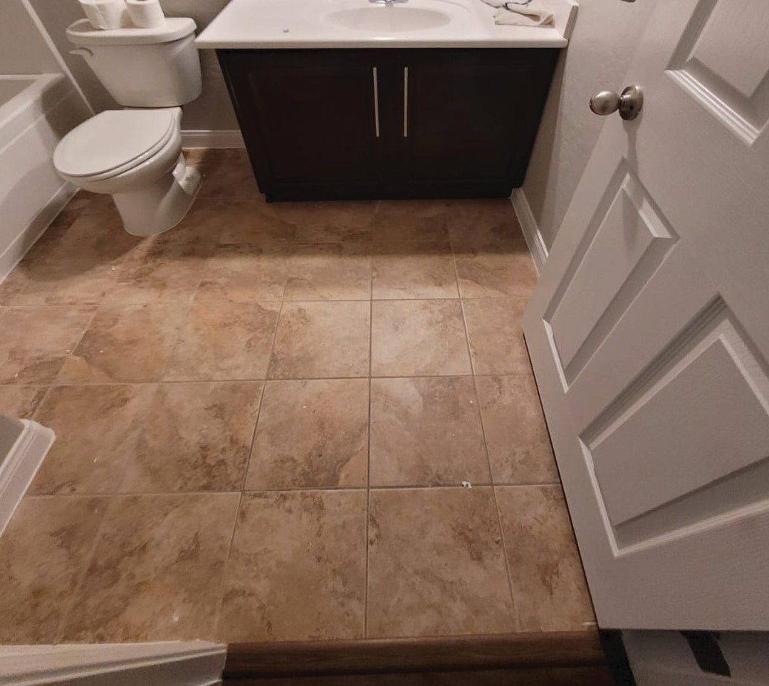 A bathroom with a toilet a sink and a bathtub